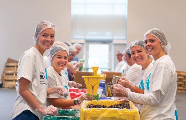 A group of students pack rice and beans for the Meals for Maine event